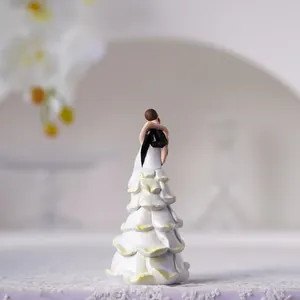European resin couple figurine with elegant multilayered petal wedding dress design