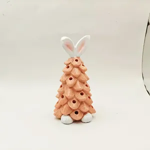 Detail of pinecone rabbit gnome figurine with ear details and perforated light holes