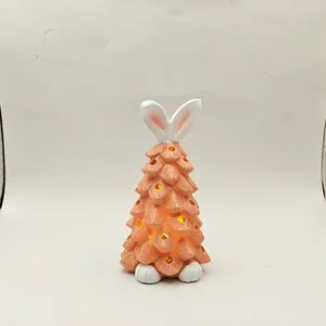 Detail of bunny ear dwarf resin tree lamp with glowing holes and warm LED lighting effect