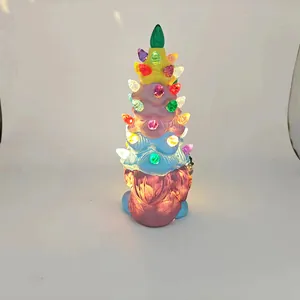 Close-up of glowing gnome Christmas tree ornament with colorful acrylic lights