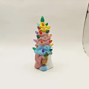 Detail view of colorful layered ceramic Christmas tree with translucent plastic bulbs