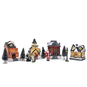 Set de aldea navideña luminosa con casas de resina nevadas y figuras decorativas miniatura