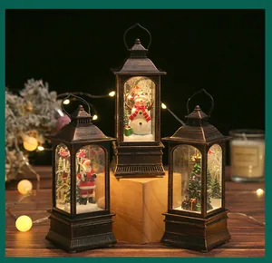 Detail of Christmas lantern set featuring Santa Claus, snowman, and tree on wood stand