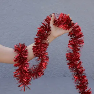 Gros plan d'une guirlande métallique rouge pelucheuse pour la décoration de fête de Noël
