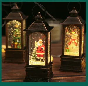 Close-up of three vintage bronze Christmas lanterns with warm LED light and swirling glitter