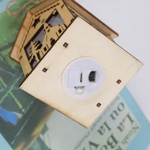 Wooden LED Christmas house pendant with laser-cut star patterns and warm light