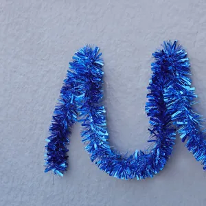 Detail of fluffy bright blue tinsel garland with star shapes for Christmas party decor