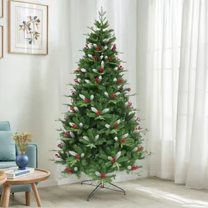 Close-up of artificial Christmas tree with red berries and realistic flocked snow effect
