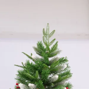Flocked Christmas tree top with red berries and snow-covered green pine needles