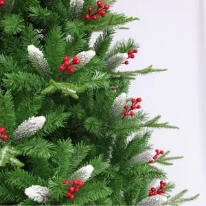 Artificial Christmas tree branches with red berries and white snowy flocked needles