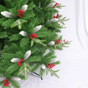 Artificial Christmas tree with red berries, pine cones and snowy flocked needles decoration