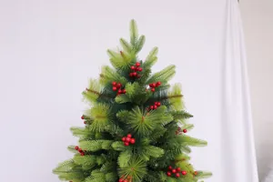 Detail of pine needles and vibrant red berries on a green artificial Christmas tree