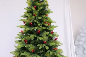 Detail of lush green pine needles with vibrant red berry ornaments on a Christmas tree