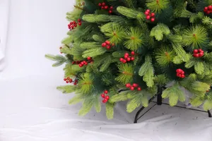 Close-up of artificial Christmas tree with dense PE pine needles and red berries