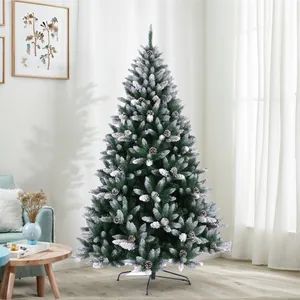 Close-up of realistic snow-flocked PE needles and pine cones on a Christmas tree