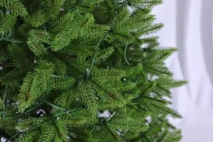 Macro shot of realistic green PE pine needles with tiny transparent LED string lights