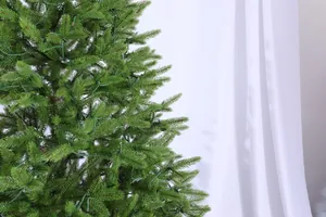 Detailed close-up of dense green PE pine needles and integrated LED light strings