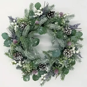 Christmas wreath with pine cones, white berries and eucalyptus on white background