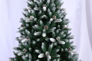 Detail of 7.5ft flocked Christmas tree with realistic snow effect and pine cones