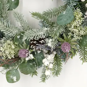Artificial Christmas wreath with eucalyptus leaves, pine cones and frosted snow effect