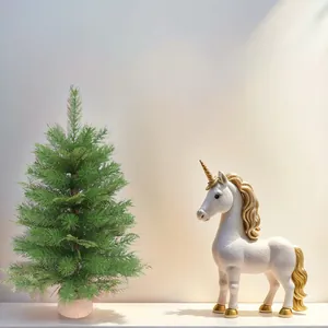 White ceramic unicorn ornament with gold accents and a small green Christmas tree