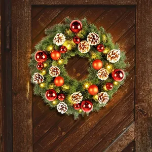 Charming Christmas wreath with pine cones and LED lights on a rustic wooden door