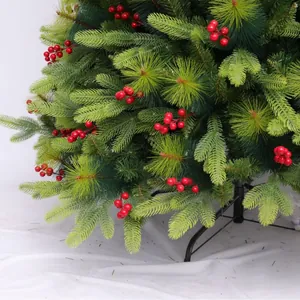 Artificial pine Christmas tree with vibrant red berries and a black metal stand base
