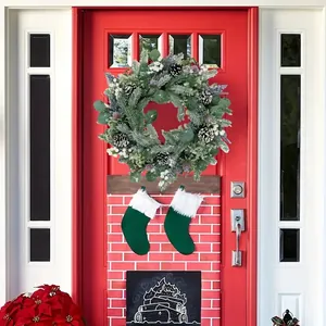 Close-up of Christmas wreath with eucalyptus, pine cones and berries on a red door