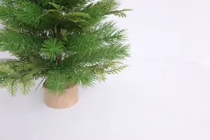 Detailed view of mini Christmas tree with PE green needles and a rustic wooden base