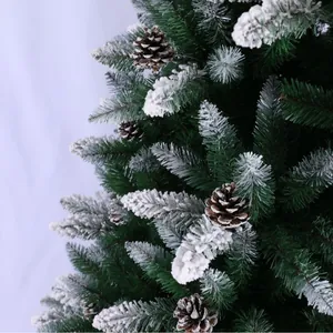 Artificial flocked Christmas tree with pine cones and dense snow-covered green needles