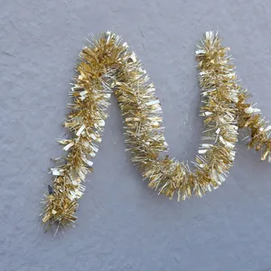 Shiny light gold Christmas tinsel garland for festive holiday party wall decoration