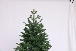 Detailed view of dense dark green PVC needles on artificial Christmas tree branches