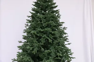 Close-up of dense green PVC pine needles on a realistic artificial Christmas tree