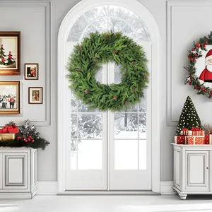Green PE pine needle wreath with natural pine cones hanging on a white interior door