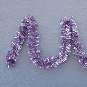 Close-up of metallic purple tinsel garland decoration with shiny reflective texture