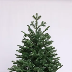 Lush deep green artificial Christmas tree with dense PVC needles and pointed top design
