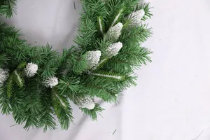 Close-up of snow-flocked pine needles and natural cones for Christmas decoration