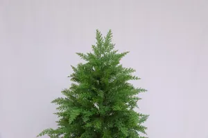 Close-up of lush artificial evergreen Christmas tree branches with natural texture