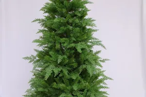Close-up of green artificial evergreen tree with realistic pine needles and layered branches