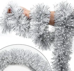 Detail of dense silver Christmas tinsel garland with shiny festive metallic finish
