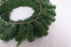 Macro view of realistic pine needles and brown branch base on a Christmas wreath