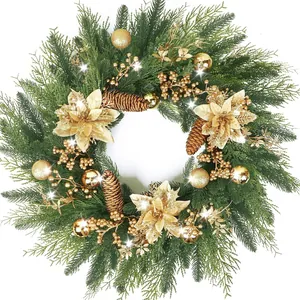 Luxury Christmas wreath with gold poinsettias pinecones and baubles on green pine base