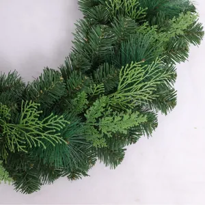 Realistic mixed pine needle and cypress PVC Christmas wreath on white marble background