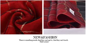 Detailed close-up of a red silk scarf featuring golden metallic threads and plaid patterns