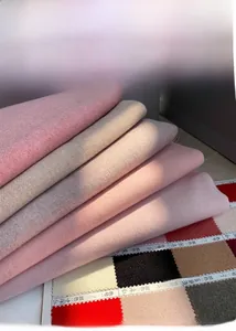 Close-up of soft cashmere winter scarves in pink and beige with detailed fabric texture