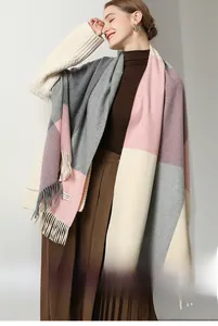 Close-up of sheep wool scarf featuring color block patterns and soft decorative tassels
