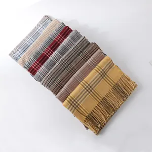 Detail shot of various colorful houndstooth scarves with fringe in a layered stack