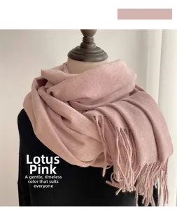 Detailed texture of dusty rose faux cashmere scarf with elegant fringe tassels on model