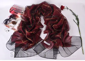 Macro shot of 100% silk red and black plaid scarf with delicate metallic gold threads