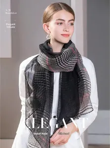 Elegant wool and silk scarf featuring black and white plaid patterns and stripes